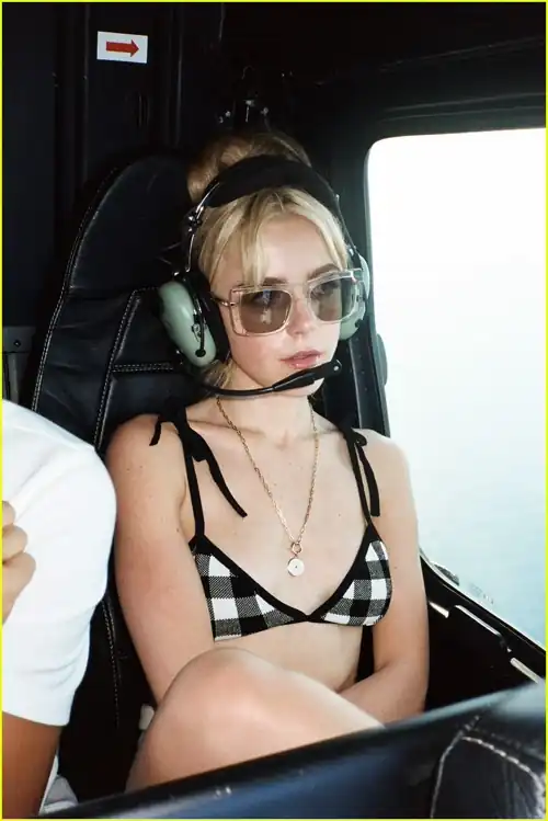 Kiki wearing a bikini top in a helicopter