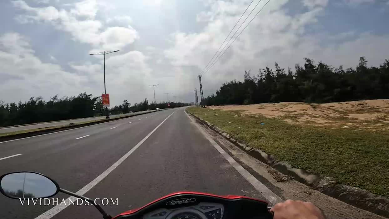 Handjob on a motorbike with people driving by