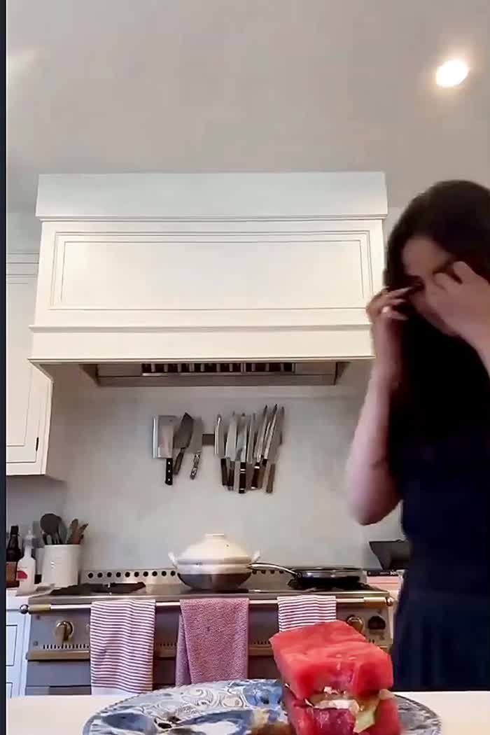 Selena eating a watermelon sandwich…