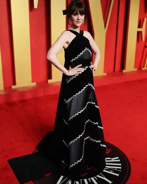 Zooey in Patou at Vanity Fair Oscars Viewing Party