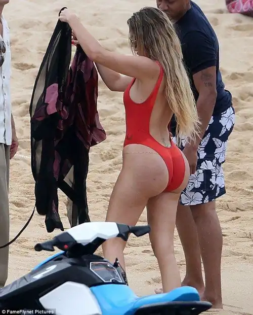 Khloe slaying in a red one piece