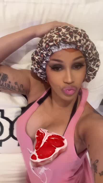 Cardi trying to cover her nipples
