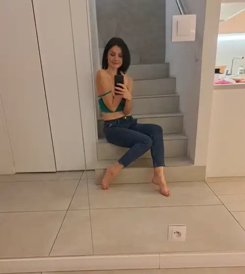 Green top and jeans. 