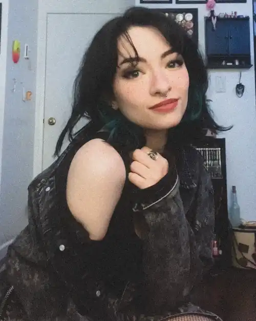 The green & black hair is quite a look on her.