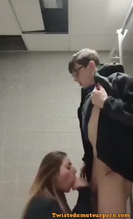 College girl gives blowjob to costudent in bathroom stalls