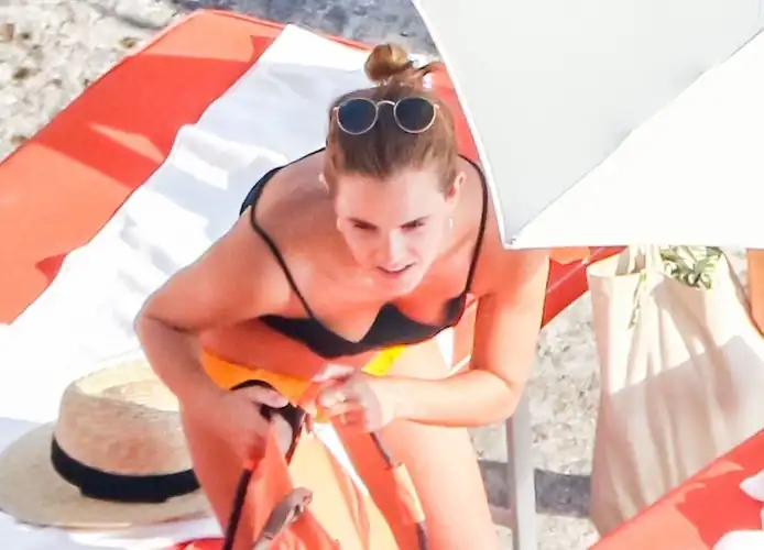 Emma Watson is on holiday and drinks cocktails