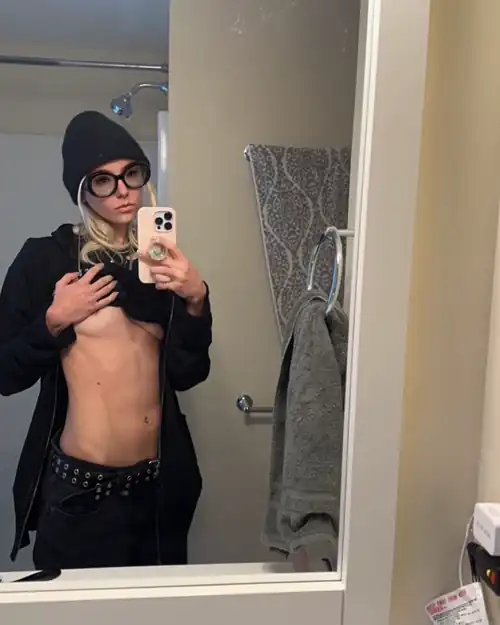 Showing off her abs in the mirror - November 2023